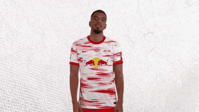 a man wearing a red and white jersey with a bull on it