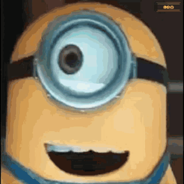 a close up of a minion 's face with a big smile