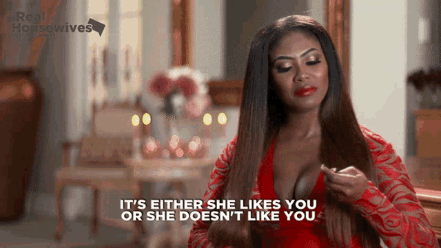 a woman in a red dress is saying it 's either she likes you or she does n't like you