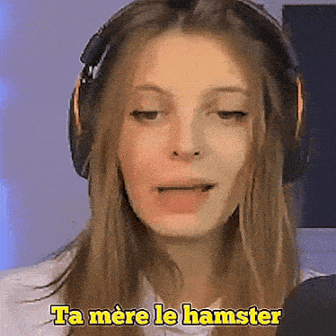 a woman wearing headphones is making a face and says ta mere le hamster