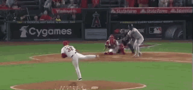 a baseball player with the number 32 on his jersey is standing on the field