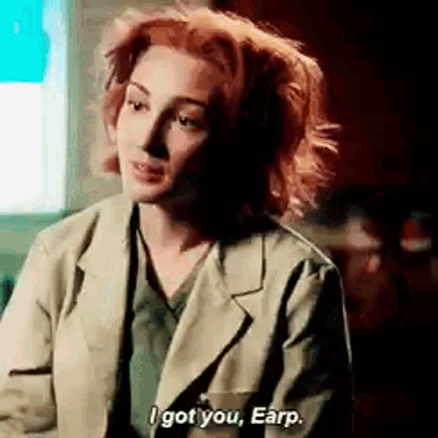 a woman with red hair is sitting in front of a computer and saying `` i got you , earp '' .