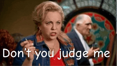 a woman in a denim jacket is holding a glass of wine and says `` don t you judge me '' .