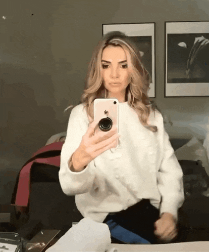 a woman is taking a selfie with her iphone