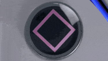 a close up of a playstation controller with a square triangle and v buttons