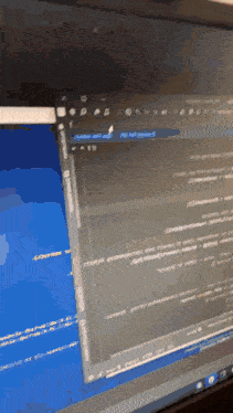 a computer monitor with a blue screen and a few lines of code on it