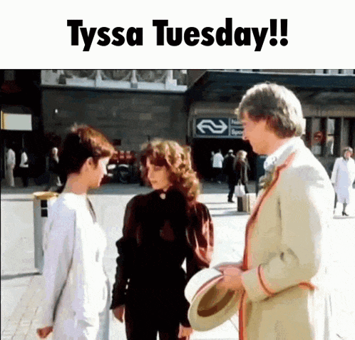 a group of people standing in front of a building with the words tyssa tuesday written on the bottom