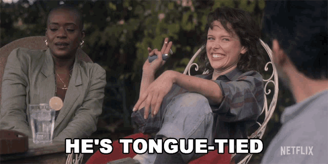 a woman sitting in a chair with the words he 's tongue-tied behind her