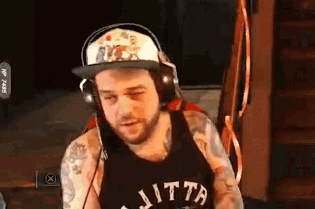 a man wearing headphones and a shirt that says ' jitta ' on it