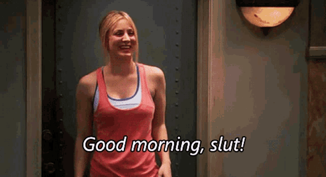 a woman is standing in front of a door and says " good morning slut "