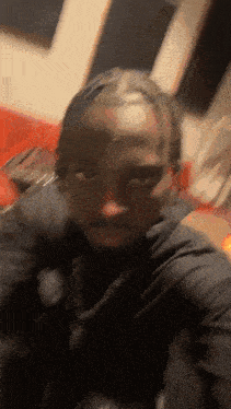 a man taking a selfie with a braided headband on