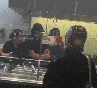 a person wearing a hat that says guacamole