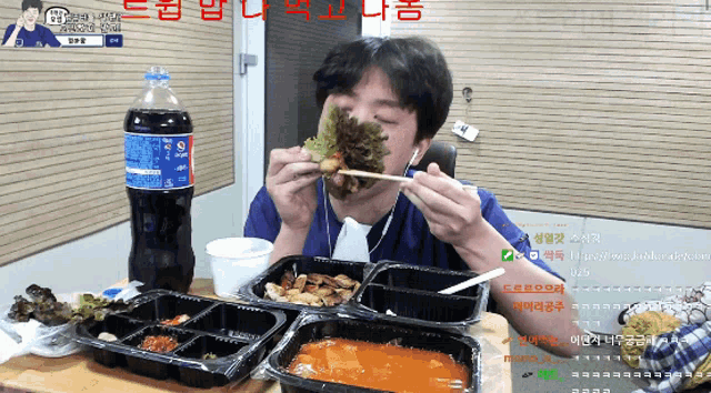 a bottle of pepsi sits on a table next to a man eating food