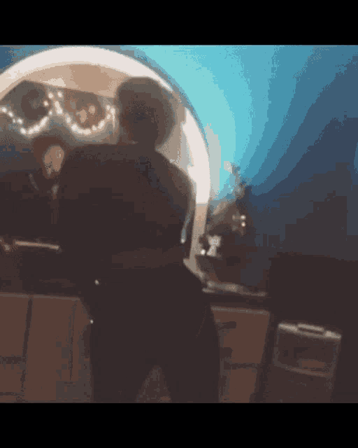 a person is standing in front of a mirror with balloons on the wall