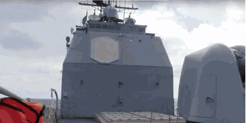 a large military ship is floating on top of a large body of water