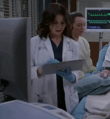 a woman in a lab coat is using a tablet