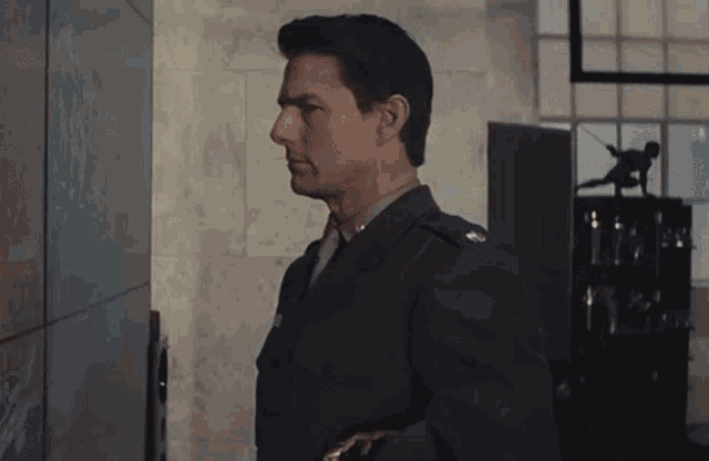 a man in a suit and tie is standing in a room