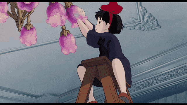 a girl with a red bow on her head is sitting on a ladder fixing a chandelier