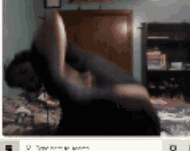a blurred image of a person doing a yoga pose in a bedroom