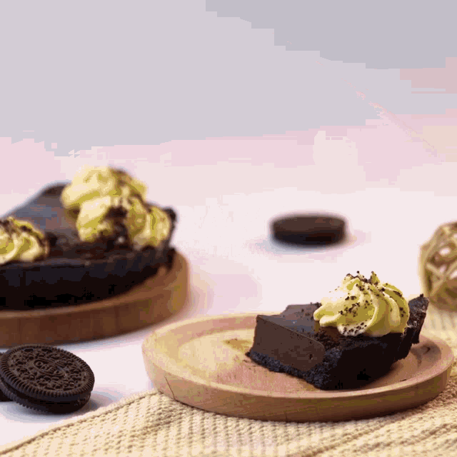 a slice of chocolate pie on a wooden plate next to oreos