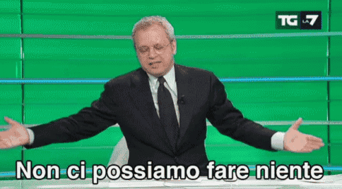 a man in a suit and tie is standing in front of a green wall and says non ci possiamo fare niente .