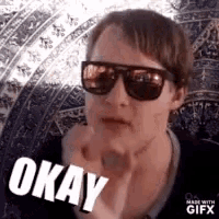 a woman wearing sunglasses is making an okay face .