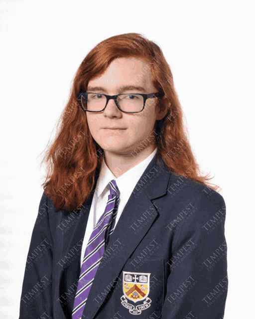 a girl with long red hair wearing glasses and a purple tie with the word tempest on it