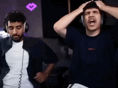 two men wearing headphones are standing next to each other in a room .