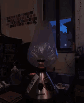 a volcano vaporizer is sitting on a table in front of a window