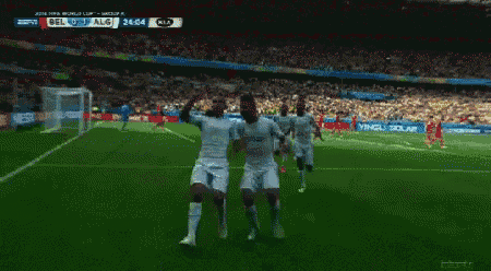 a group of soccer players celebrate a goal during a match