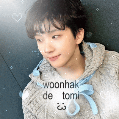 a young man wearing a sweater with woonhak de tomi written on the front