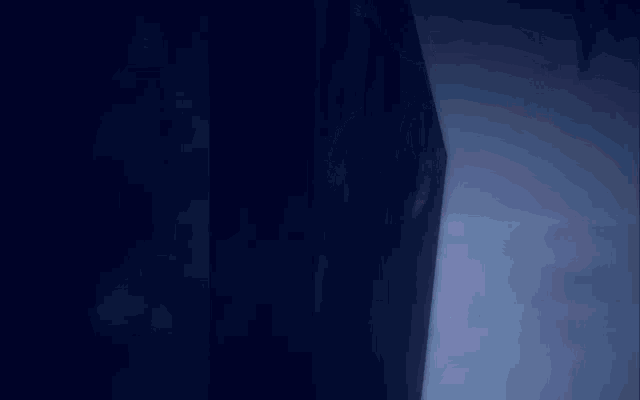 a cartoon character is peeking out from behind a black curtain
