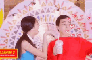 a man and a woman are standing next to each other with hearts drawn on their faces .