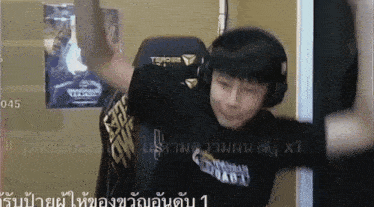 a man wearing headphones and a black shirt that says ' assault ' on it