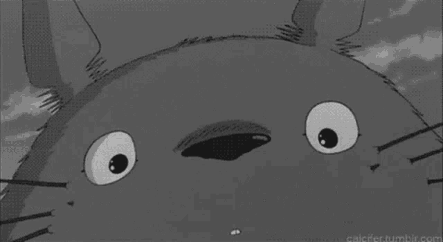 a black and white drawing of a cartoon character with a big smile on its face .