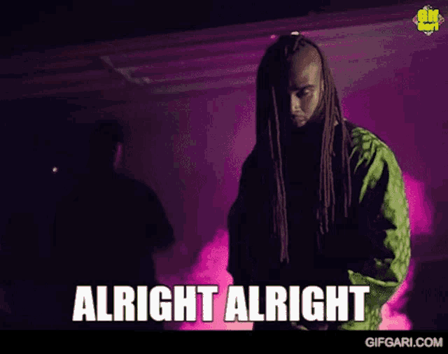 a man with dreadlocks is dancing in a dark room with the words alright alright written below him