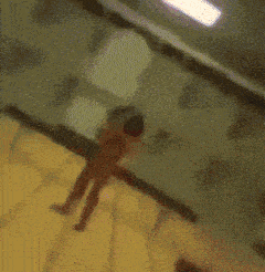 a blurry image of a man with a beard and a red shirt