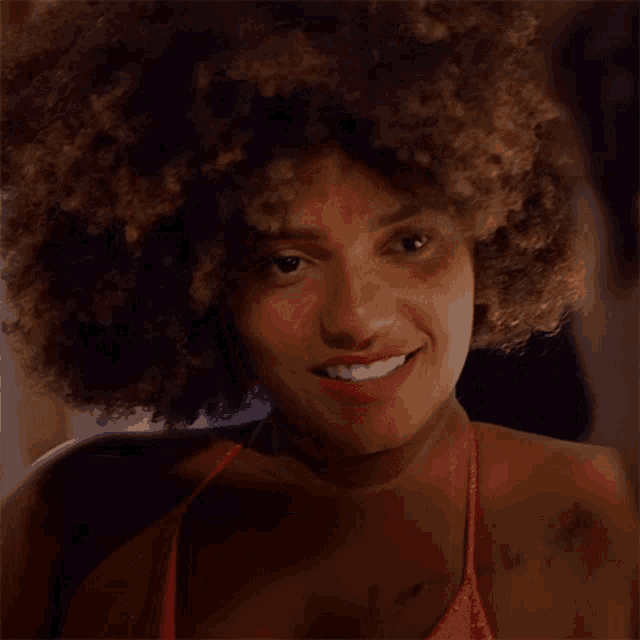 a woman with an afro has the word no on her chest