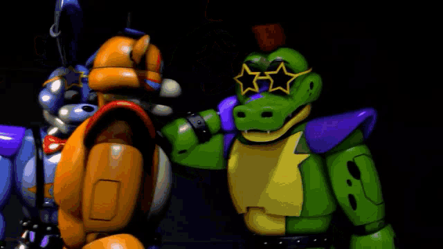a yellow robot and a green crocodile are standing next to each other wearing sunglasses .