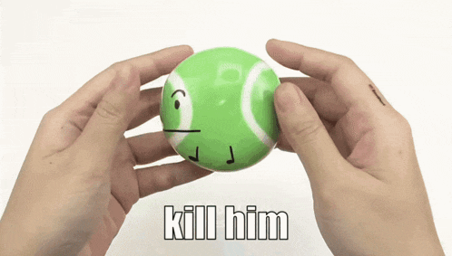 a person holding a green tennis ball with a face drawn on it