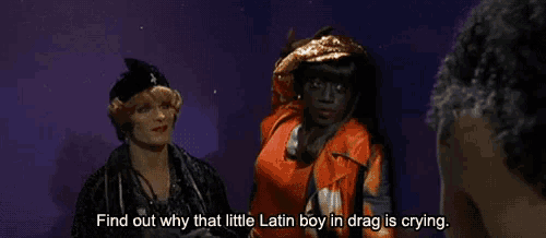 two women are standing next to each other with the words find out why that little latin boy in drag is crying