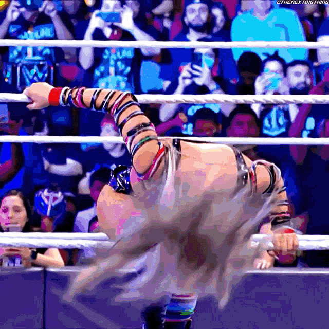 a wrestler in a ring with the hashtag thenextbigthing on the bottom right corner