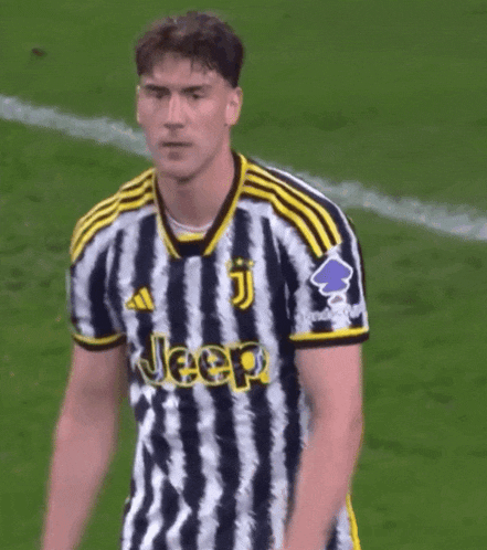 a soccer player wearing a jeep jersey stands on a field