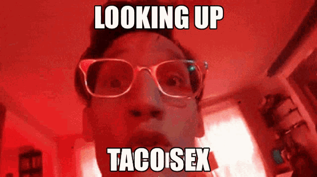 a man wearing glasses looks up at the camera with the caption looking up taco sex