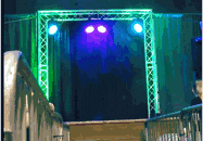 a stage with blue and green lights and a purple light