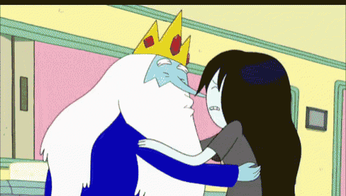 a cartoon character named ice king is hugging a girl
