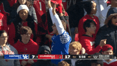 a crowd of people watching a college football game between kentucky and 10 louisville