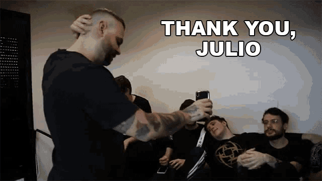 a man taking a picture of his friends with the words thank you julio