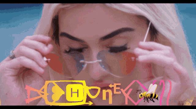 a woman wearing sunglasses with a bee and the word honey on it
