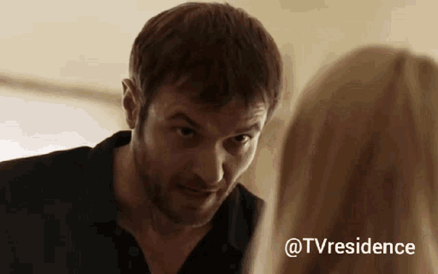 a man with a beard is looking at a woman with the hashtag @tvresidence on the bottom